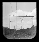841319 Gezicht op de spoorbaan tussen Wolfheze en Ede-Wageningen, vanuit een rijdende trein.